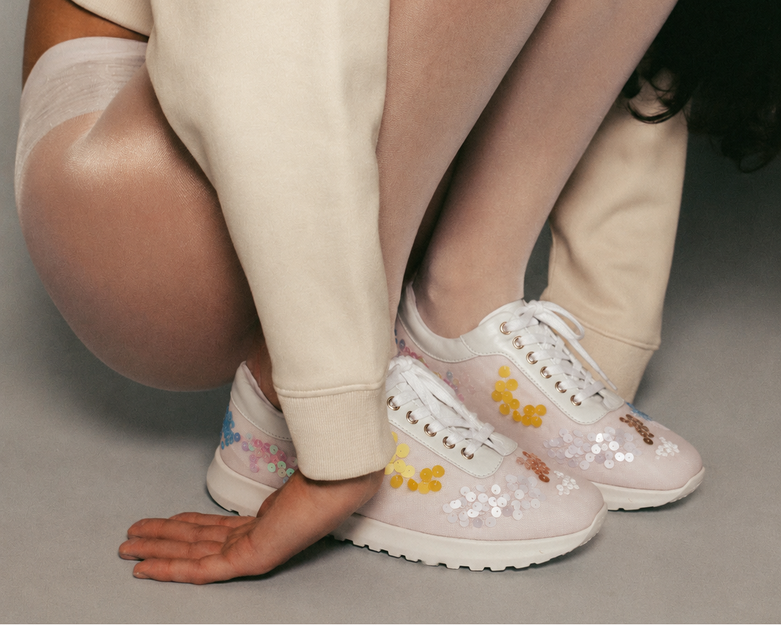 Model wearing luxury  sneakers with embroidered sequins